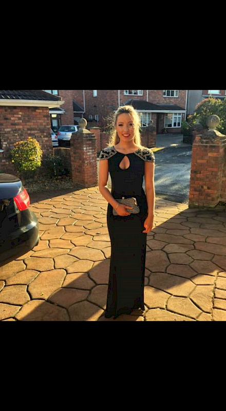 Black figure hugging dress with silver embellished shoulders