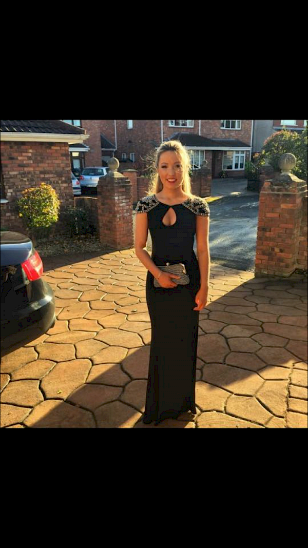 Black figure hugging dress with silver embellished shoulders